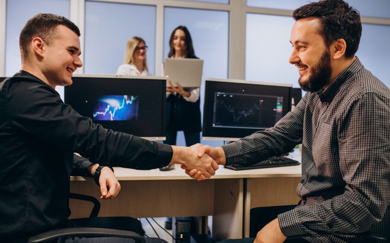 Workers at an IT company working on a computer