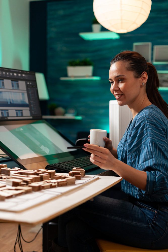 Website design - woman holding a mug at a desk beside a laptop and wooden blocks