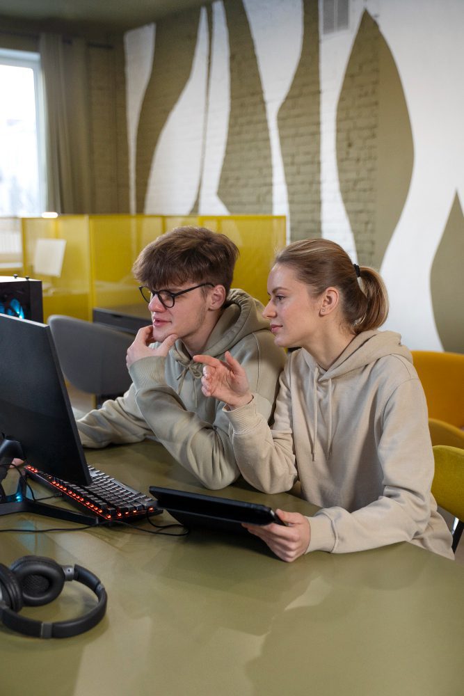 Website design - two young people looking at a computer screen together