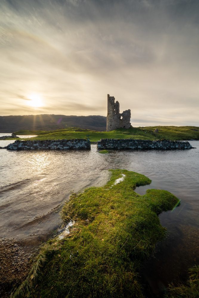 Website design - ruined castle on a headland at sunset on the Northumberland coast