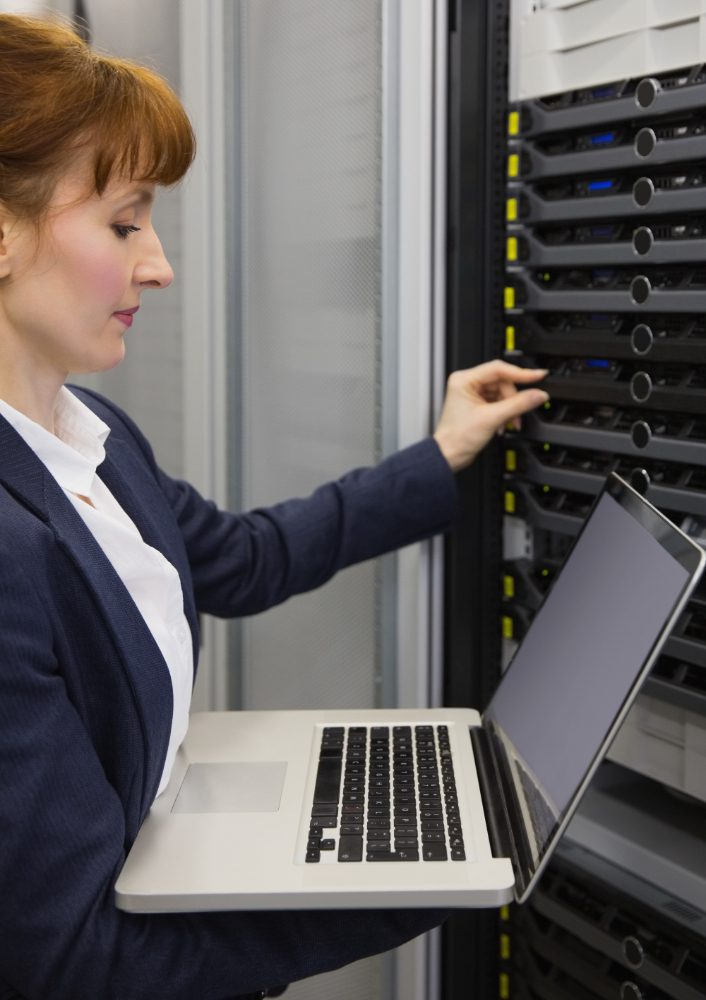 Web hosting - engineer working at a server rack with a laptop