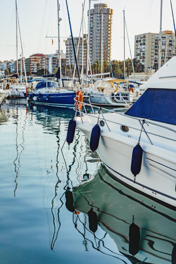Website design - yachts moored in a marina with waterfront apartments behind