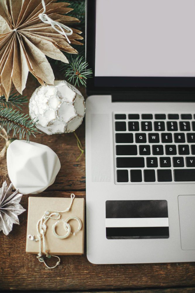 Website design - flat lay of a laptop with paper decorations and jewellery