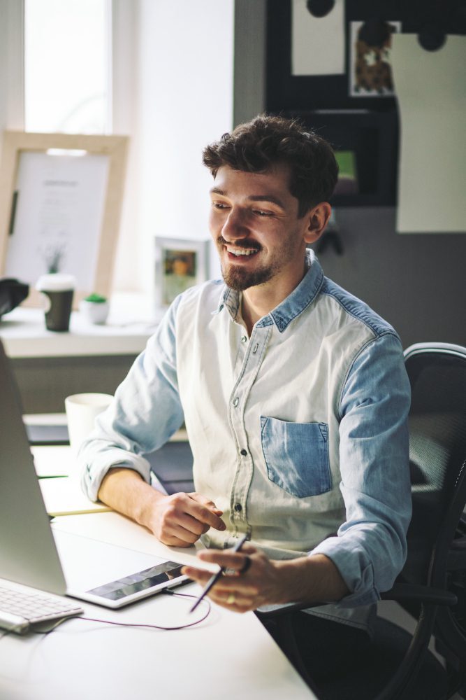 Website design - man working at a desk in a bright office