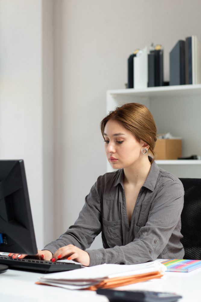 Website design - woman working at a desktop computer in an office