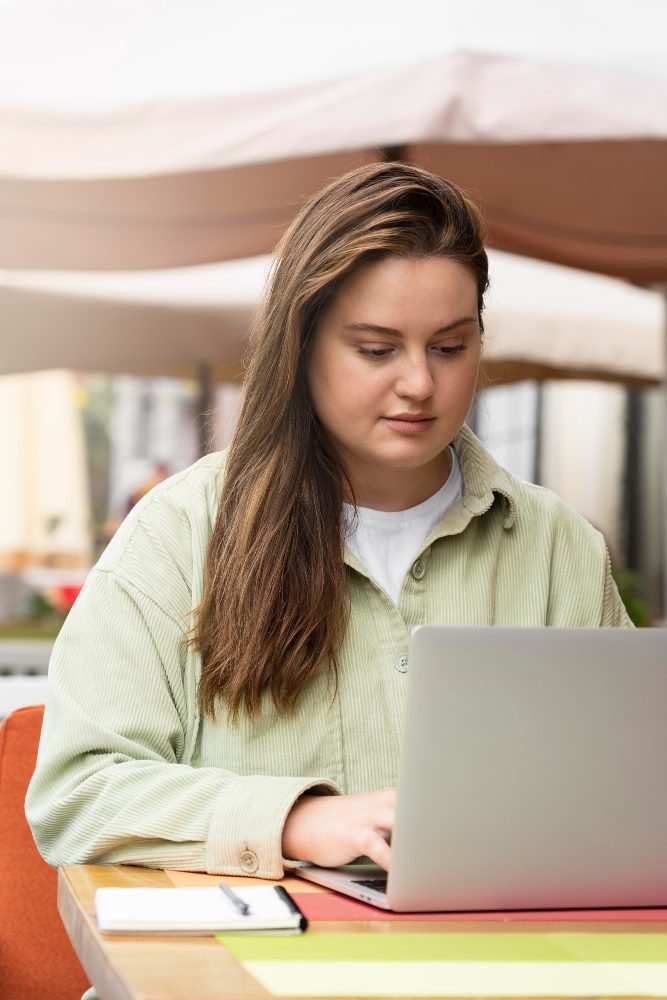 Website design - young woman working at a laptop