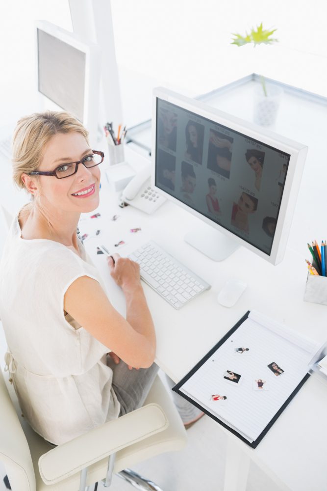 Website design - dental practice manager at a desk with X-rays on screen