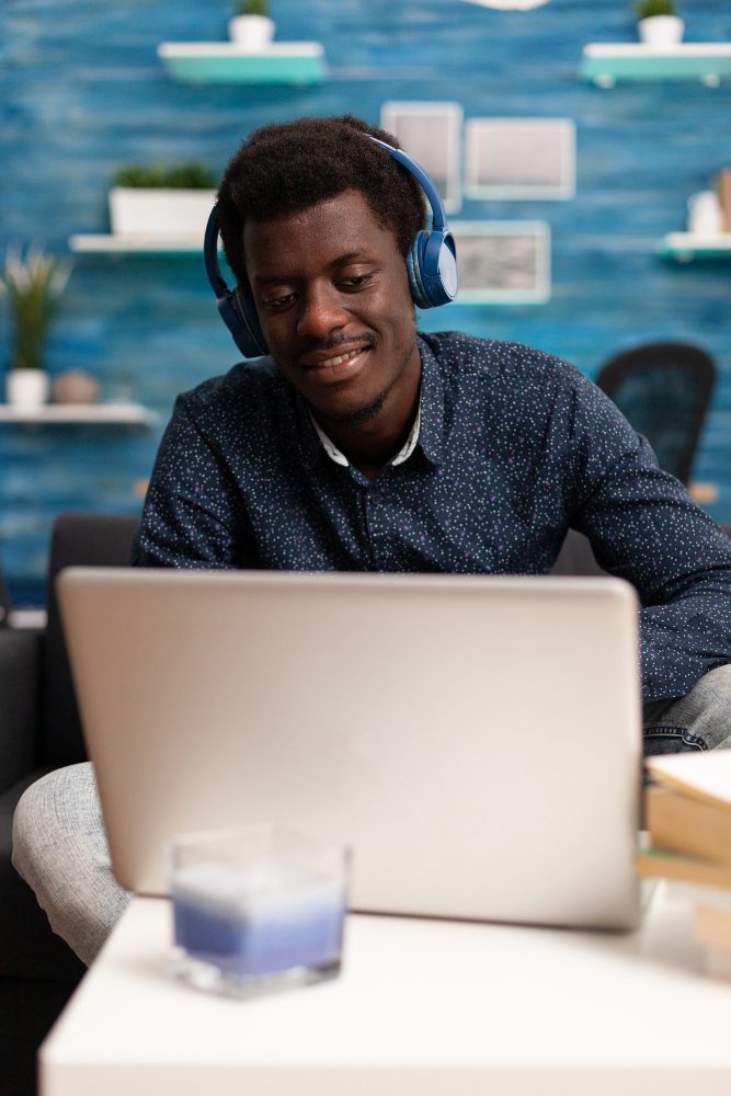 Website design - man wearing headphones working at a laptop