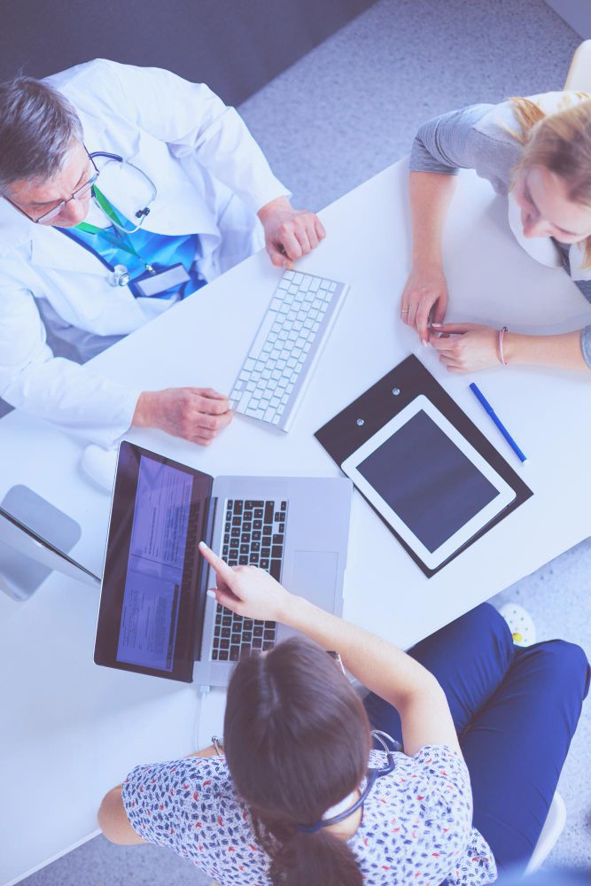 Medical website design in Newcastle - a clinical team working across laptops and tablets