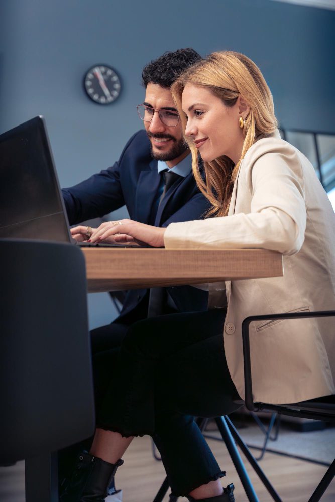 Website design - two colleagues working together at a desktop computer