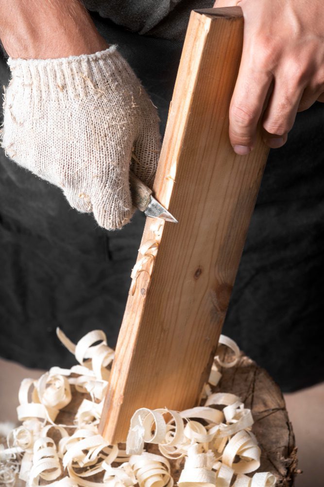 Trade website design in Doncaster - a joiner planing a length of timber with shavings on the bench