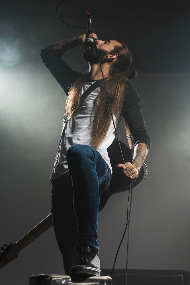 Social media - singer performing into a microphone on a smoke-filled stage