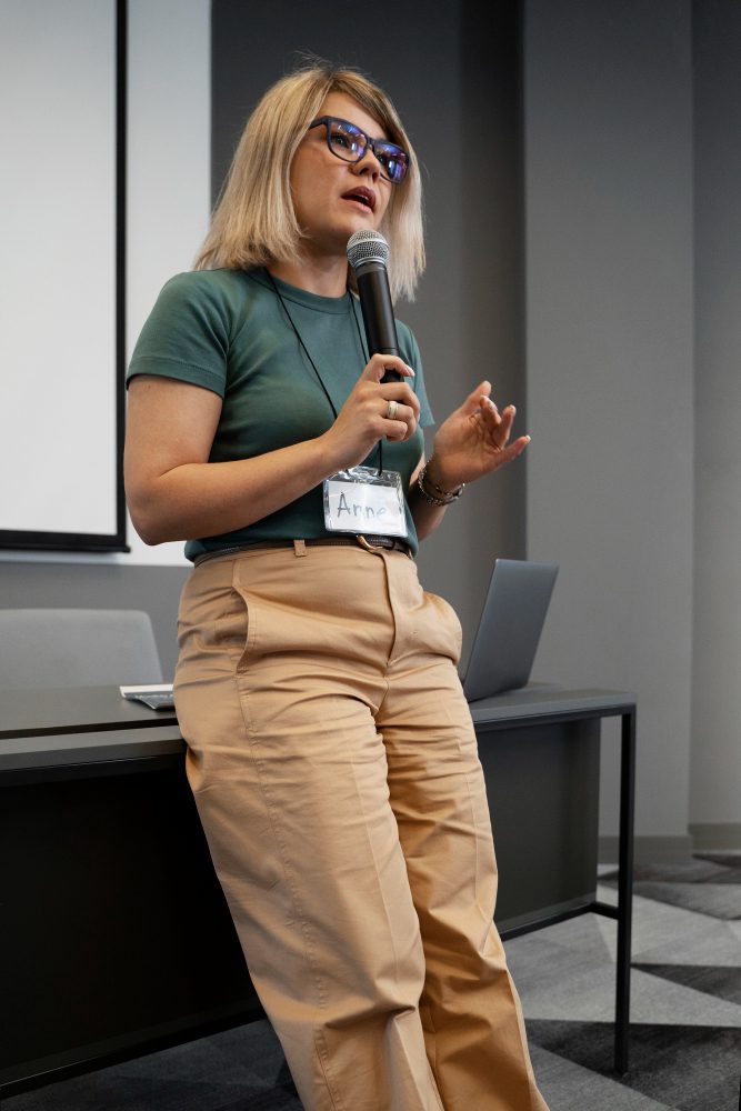 Social media - woman speaking into a microphone at a conference