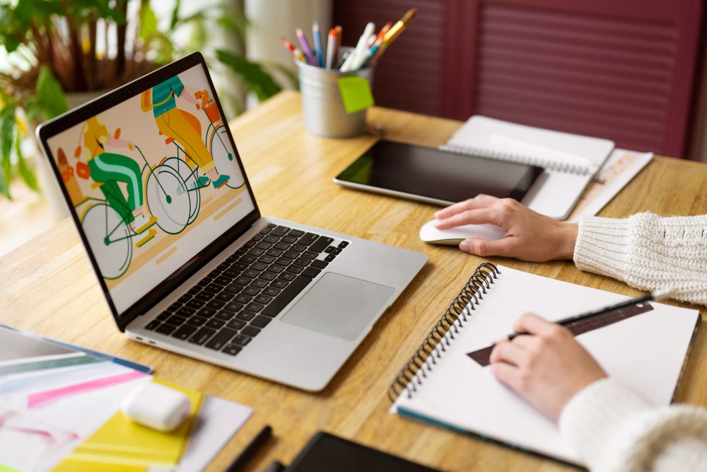 County Durham web design questions answered - a laptop showing an illustration beside a notebook