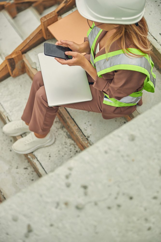 Construction website design in Doncaster - a hi-vis worker using a tablet on site