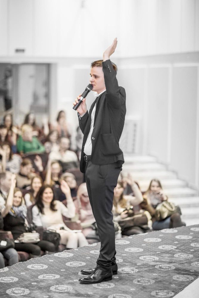 Social media - speaker with a microphone addressing a seated audience