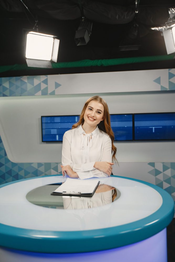 Website design - television presenter sitting at a desk in a news studio