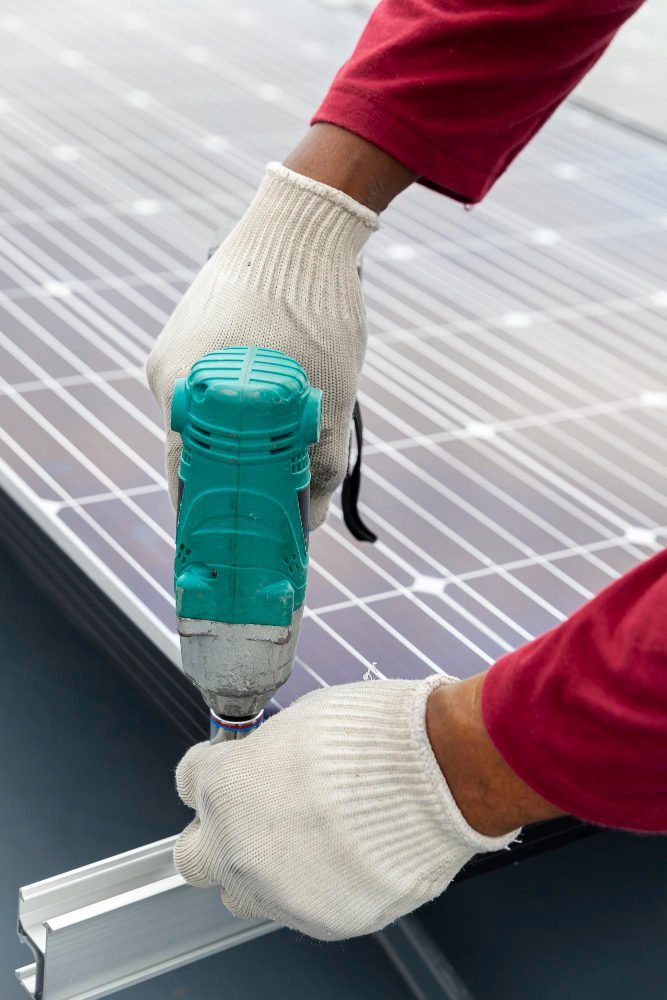 Website design - worker fitting solar panels with a power tool