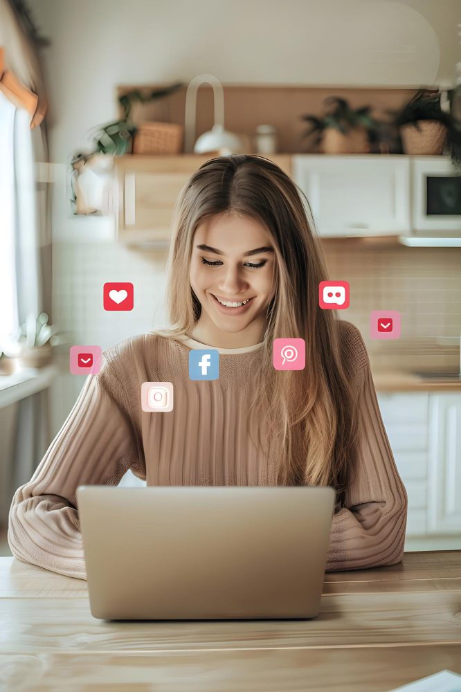 Woman at a laptop with social media icons floating