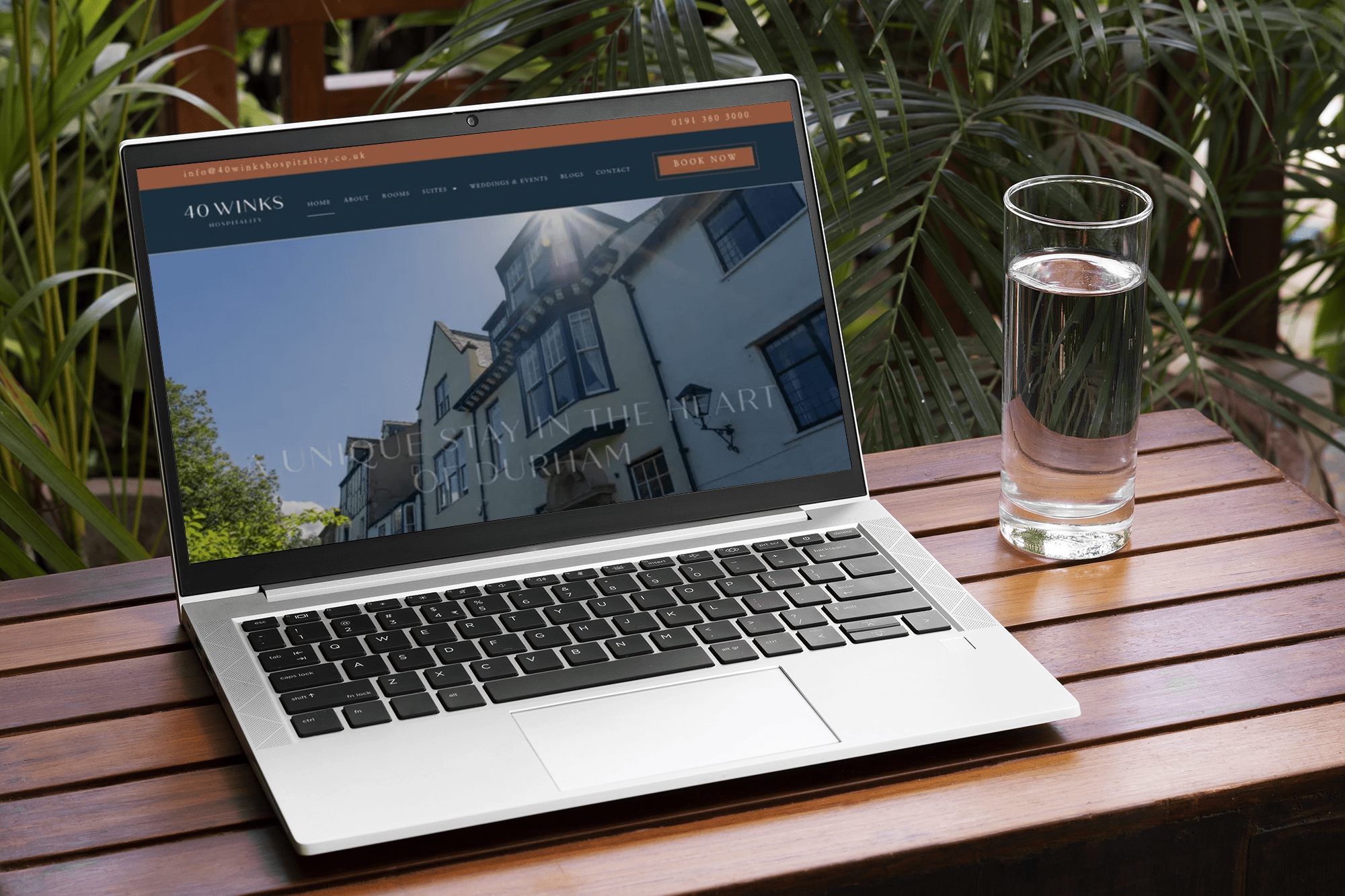 Laptop showing a property website on an outdoor table